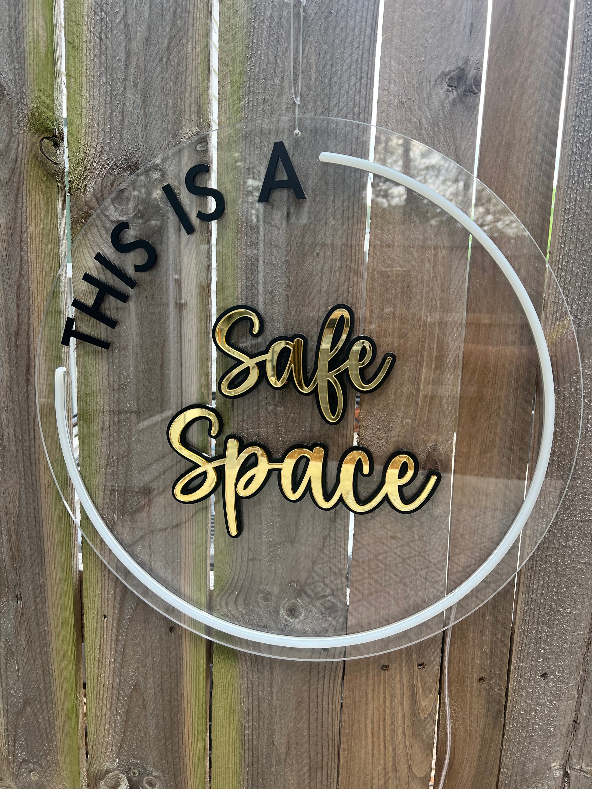 LED circular sign with the words 'This is a safe space' illuminated in vibrant white LED. Adds a welcoming and inclusive atmosphere to any environment.