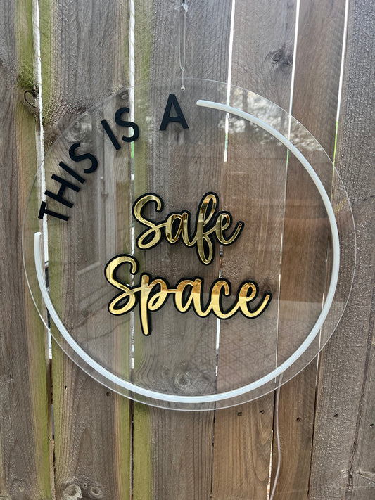 LED circular sign with the words 'This is a safe space' illuminated in vibrant white LED. Adds a welcoming and inclusive atmosphere to any environment.