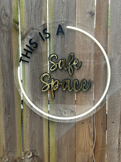 LED circular sign with the words 'This is a safe space' illuminated in vibrant white LED. Adds a welcoming and inclusive atmosphere to any environment.